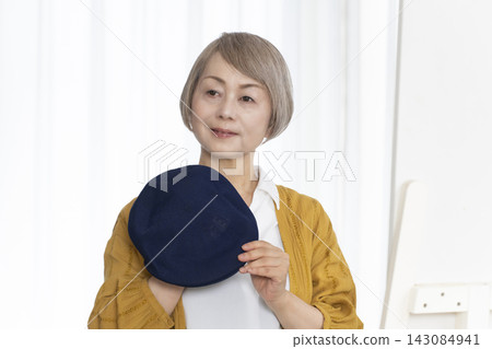 Senior women choosing hats and dressing stylishly Senior women choosing hats and dressing stylishly 143084941