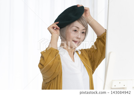 老年婦女挑選帽子和穿著時尚 老年婦女挑選帽子和穿著時尚 143084942