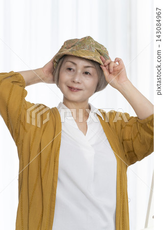 Senior women choosing hats and dressing stylishly Senior women choosing hats and dressing stylishly 143084967