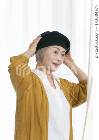 Senior women choosing hats and dressing stylishly Senior women choosing hats and dressing stylishly 143084977
