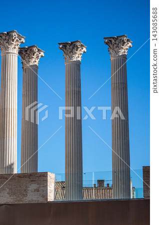 Enjoying historic architecture while walking through charming streets and urban spaces in Cordoba, Spain. 143085688