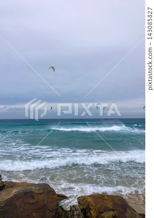 A windsurfer rides strong Atlantic winds off Tarifa, Spain, capturing speed, freedom, and coastal energy. A windsurfer rides strong Atlantic winds off Tarifa, Spain, capturing speed, freedom, and coastal energy. 143085827