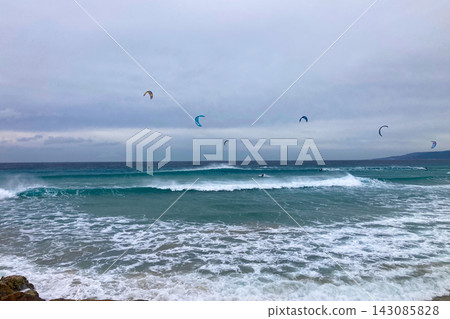 A windsurfer rides strong Atlantic winds off Tarifa, Spain, capturing speed, freedom, and coastal energy. A windsurfer rides strong Atlantic winds off Tarifa, Spain, capturing speed, freedom, and coastal energy. 143085828