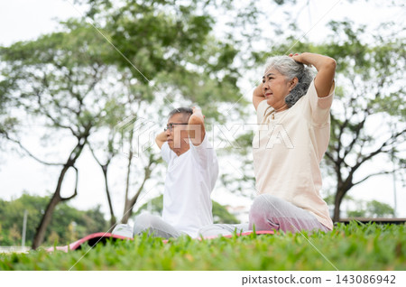 Senior Couple Meditation on Yoga Mat Outdoor in Park, Health and Wellness. Senior Couple Meditation on Yoga Mat Outdoor in Park, Health and Wellness. 143086942