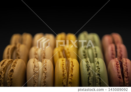 macaroons of different colors on a black background macaroons of different colors on a black background 143089092