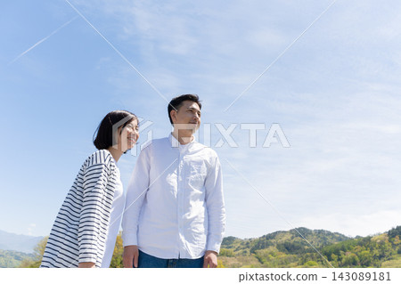 一對情侶在藍天下凝望遠方。 143089181