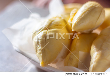 Fresh Thai durian flesh with creamy texture and rich flavor, tropical fruit enjoyed by many worldwide. Fresh Thai durian flesh with creamy texture and rich flavor, tropical fruit enjoyed by many worldwide. 143089916