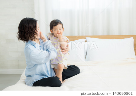 A mother holding her one-year-old daughter. A mother holding her one-year-old daughter. 143090801