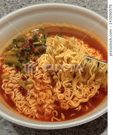 A steaming bowl of ramyeon with chewy noodles, rich and spicy broth, and flavorful toppings like green onions, egg, and vegetables. A quick and satisfying comfort food favorite. A steaming bowl of ramyeon with chewy noodles, rich and spicy broth, and flavorful toppings like green onions, egg, and vegetables. A quick and satisfying comfort food favorite. 143090978