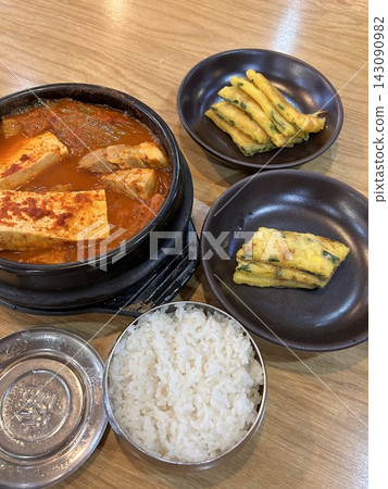 A vibrant spread of Korean food on the table, featuring various banchan (side dishes) like kimchi, pickled vegetables, and seasoned greens. Perfect for food photography, showcasing traditional Korean. A vibrant spread of Korean food on the table, featuring various banchan (side dishes) like kimchi, pickled vegetables, and seasoned greens. Perfect for food photography, showcasing traditional Korean. 143090982