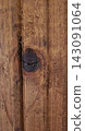 Natural dark knot on stained wooden plank texture 143091064