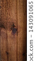 Polished brown wooden board texture with vertical grain and knots 143091065