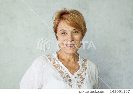 Joyful elegant senior woman wearing casual white shirt standing over grey background Joyful elegant senior woman wearing casual white shirt standing over grey background 143091107