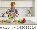 Attractive woman chef in kitchen 143091114