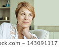 Confident mature woman with a cute smile and natural look, proudly showing her wrinkles 143091117