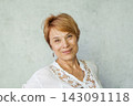 Confident real woman 60s indoors 143091118