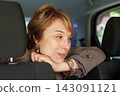 Real woman passenger sitting in car, closeup portrait 143091121