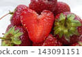 Heart shaped strawberry slice on top of fresh berries 143091151