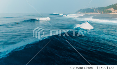 Drone view of powerful ocean waves breaking in blue water near the coast Drone view of powerful ocean waves breaking in blue water near the coast 143091528