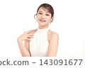 A beautiful young Asian woman with clean, fresh skin against a white background. Skincare, facial treatment, cosmetology, beauty, and spa. An elegant portrait of an Asian woman. 143091677