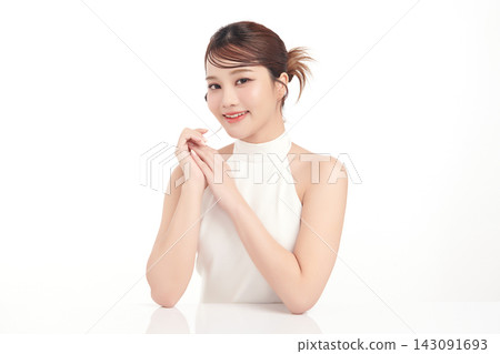 A beautiful young Asian woman with clean, fresh skin against a white background. Skincare, facial treatment, cosmetology, beauty, and spa. An elegant portrait of an Asian woman. A beautiful young Asian woman with clean, fresh skin against a white background. Skincare, facial treatment, cosmetology, beauty, and spa. An elegant portrait of an Asian woman. 143091693