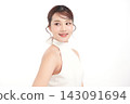 A beautiful young Asian woman with clean, fresh skin against a white background. Skincare, facial treatment, cosmetology, beauty, and spa. An elegant portrait of an Asian woman. 143091694