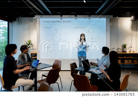 A businesswoman presents on team capabilities and organizational structure. A businesswoman presents on team capabilities and organizational structure. 143091765