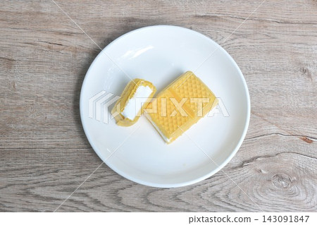 yellow wafer stuffed vanilla milk ice cream cutting arranging on white plate yellow wafer stuffed vanilla milk ice cream cutting arranging on white plate 143091847