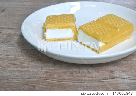 yellow wafer stuffed vanilla milk ice cream cutting arranging on white plate yellow wafer stuffed vanilla milk ice cream cutting arranging on white plate 143091848