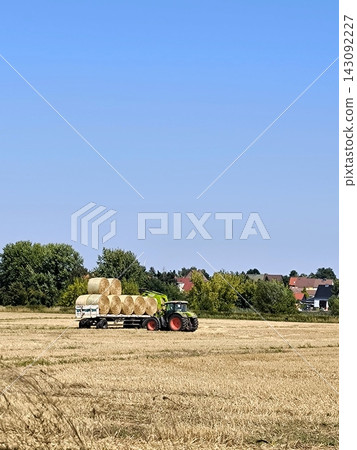 Harvesting: tractor with trailer full of hay Harvesting: tractor with trailer full of hay 143092227
