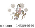 A woman sitting on a bench drinking a beverage against a backdrop of autumn leaves. 143094649