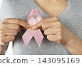 Breast Cancer Awareness Ribbon Held by Woman 143095169