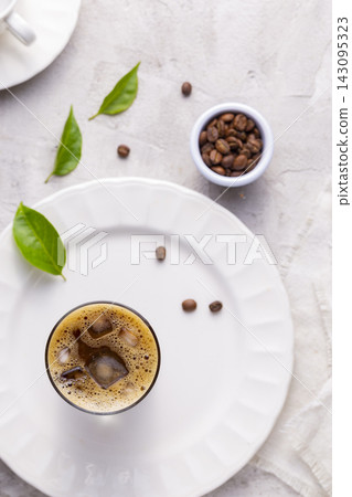 Refreshing iced coffee, with roasted coffee beans, on white background Refreshing iced coffee, with roasted coffee beans, on white background 143095323