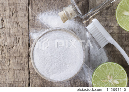 baking soda and lemon on wooden table baking soda and lemon on wooden table 143095340