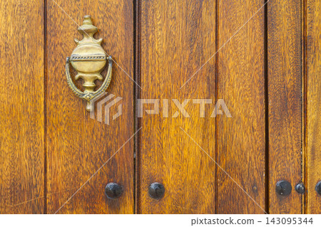 Metal detail of an old wooden door, close-up Metal detail of an old wooden door, close-up 143095344