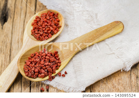 Achiote grains in container, typical condiment of South America, close-up image Achiote grains in container, typical condiment of South America, close-up image 143095524