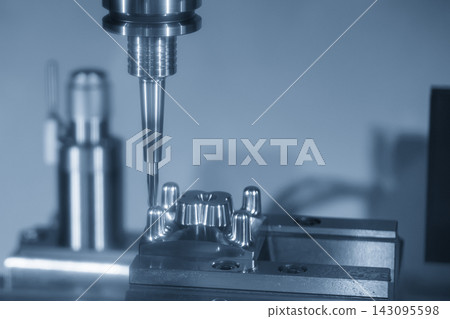 The injection mold parts finishing cut process on a CNC milling machine with a ball nose end mill in a blue tone scene The injection mold parts finishing cut process on a CNC milling machine with a ball nose end mill in a blue tone scene 143095598