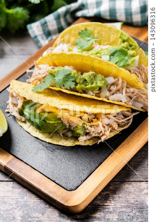 Mexican chicken tacos with guacamole and cilantro Mexican chicken tacos with guacamole and cilantro 143096316