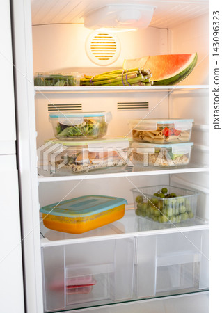 Organized refrigerator filled with healthy food and meal prep containers Organized refrigerator filled with healthy food and meal prep containers 143096323