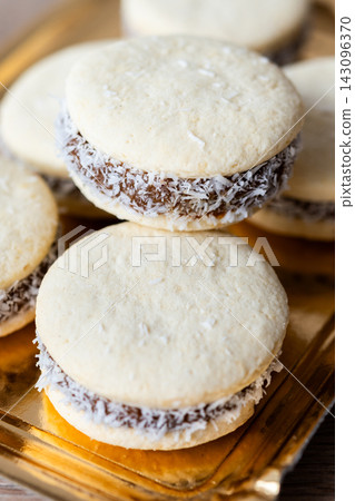 Traditional alfajores with dulce de leche and coconut Traditional alfajores with dulce de leche and coconut 143096370