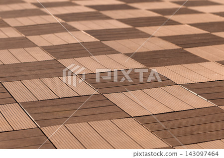 Close-up view of a wooden tile checkerboard pattern on outdoor flooring Close-up view of a wooden tile checkerboard pattern on outdoor flooring 143097464