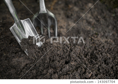 Garden tools digging fertile soil Garden tools digging fertile soil 143097704
