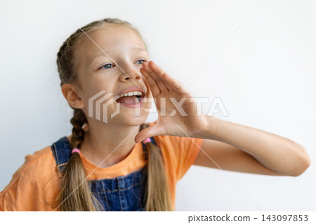 Cheerful teen girl cupping hand around mouth as if making an announcement Cheerful teen girl cupping hand around mouth as if making an announcement 143097853