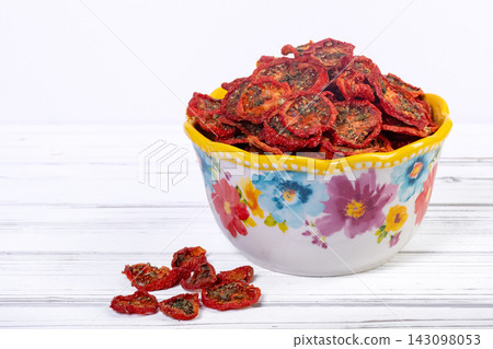 Bowl with dehydrated red fragrant tomatoes with herbs and spices. Bowl with dehydrated red fragrant tomatoes with herbs and spices. 143098053