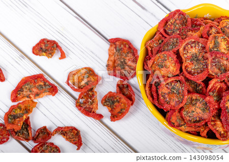 Bowl with dehydrated red fragrant tomatoes with herbs and spices. Bowl with dehydrated red fragrant tomatoes with herbs and spices. 143098054