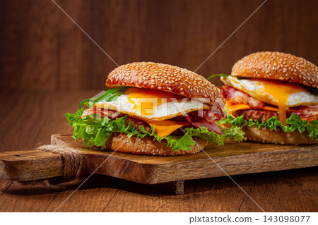 burgers with eggs, cheese and herbs, served on a wooden board, homemade, no people, burgers with eggs, cheese and herbs, served on a wooden board, homemade, no people, 143098077