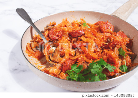 Bigos, Polish dish bigos, on a marble table, stewed meat with cabbage, chorizo sausages, mushrooms, homemade, without people, Bigos, Polish dish bigos, on a marble table, stewed meat with cabbage, chorizo sausages, mushrooms, homemade, without people, 143098085