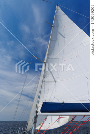 White sail against blue sky on sailing yacht White sail against blue sky on sailing yacht 143099205