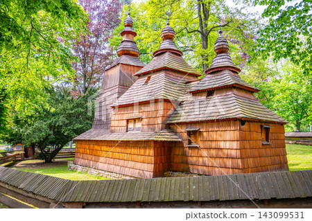 St. Nicholas church stands in Jiraskovy orchards. This wooden church was built in the 16th century and later moved to its current location. The area is surrounded by trees. St. Nicholas church stands in Jiraskovy orchards. This wooden church was built in the 16th century and later moved to its current location. The area is surrounded by trees. 143099531