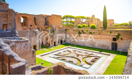 The Fountain of the Pelte is part of the Roman Forum in Rome, Italy. It features a geometric design and is surrounded by ancient ruins and green spaces under bright sunlight. The Fountain of the Pelte is part of the Roman Forum in Rome, Italy. It features a geometric design and is surrounded by ancient ruins and green spaces under bright sunlight. 143099714
